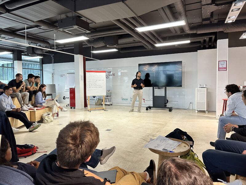 Onur Yılmaz presenting to fellow founders during a European Venture Programme workshop at EPFL